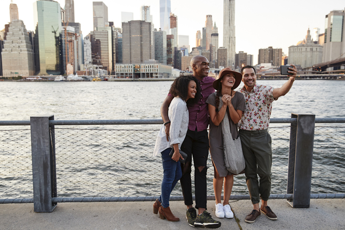 http://Group%20Of%20Friends%20Posing%20For%20Selfie%20In%20Front%20Of%20Manhattan%20Skyline