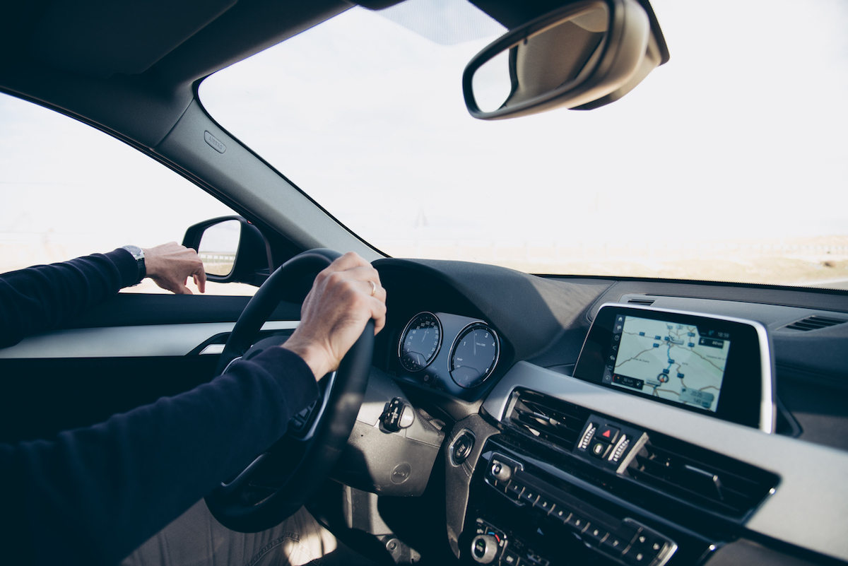 Side View Of Man Driving Car With Navigation Gps