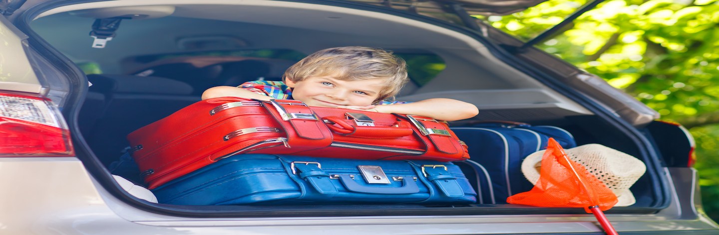 Little Kid Boy Sitting In Car Trunk Just Before Leaving For Vacation